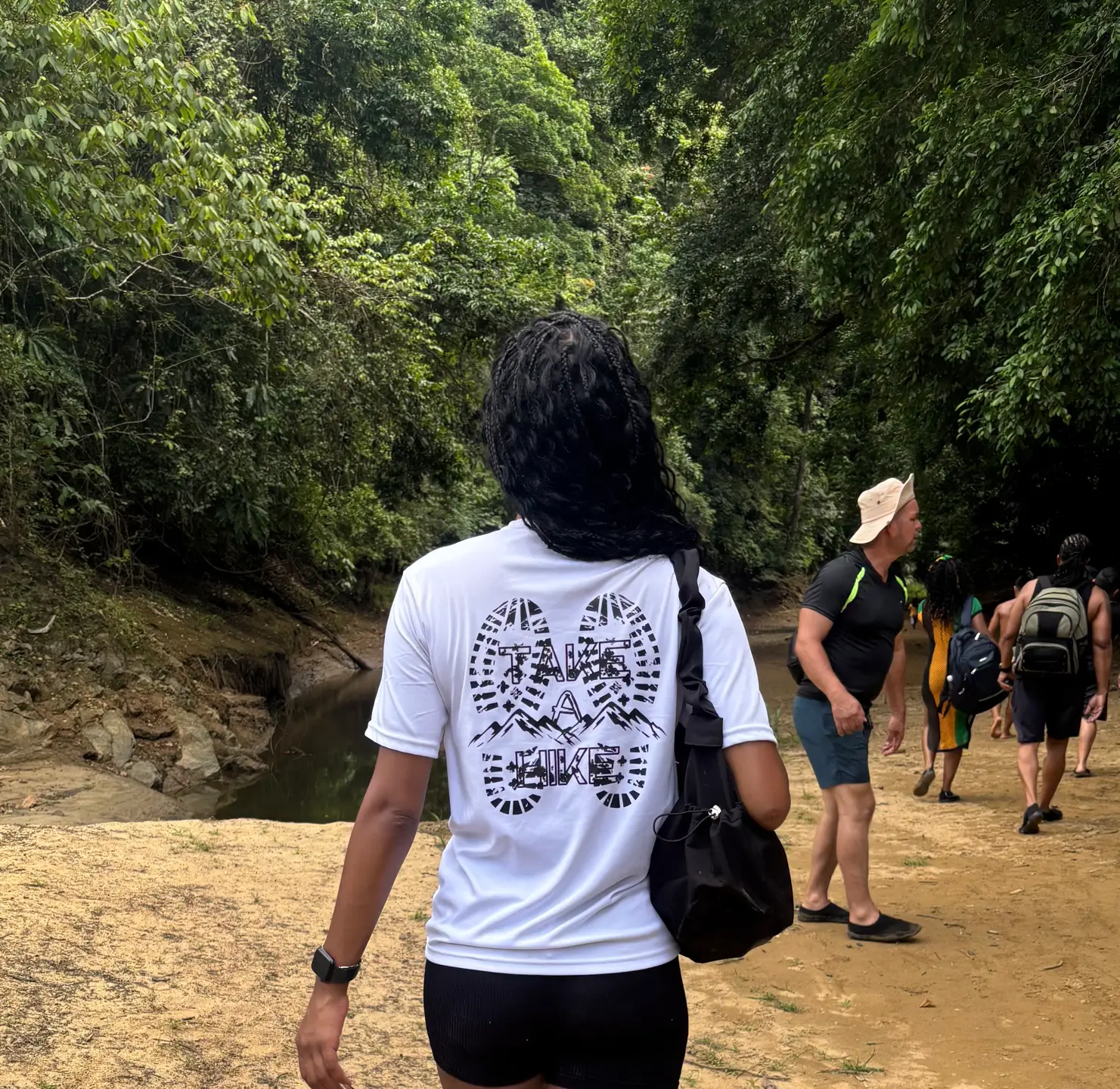 Woman wearing the Take A Hike tee on a jungle trail in Panama