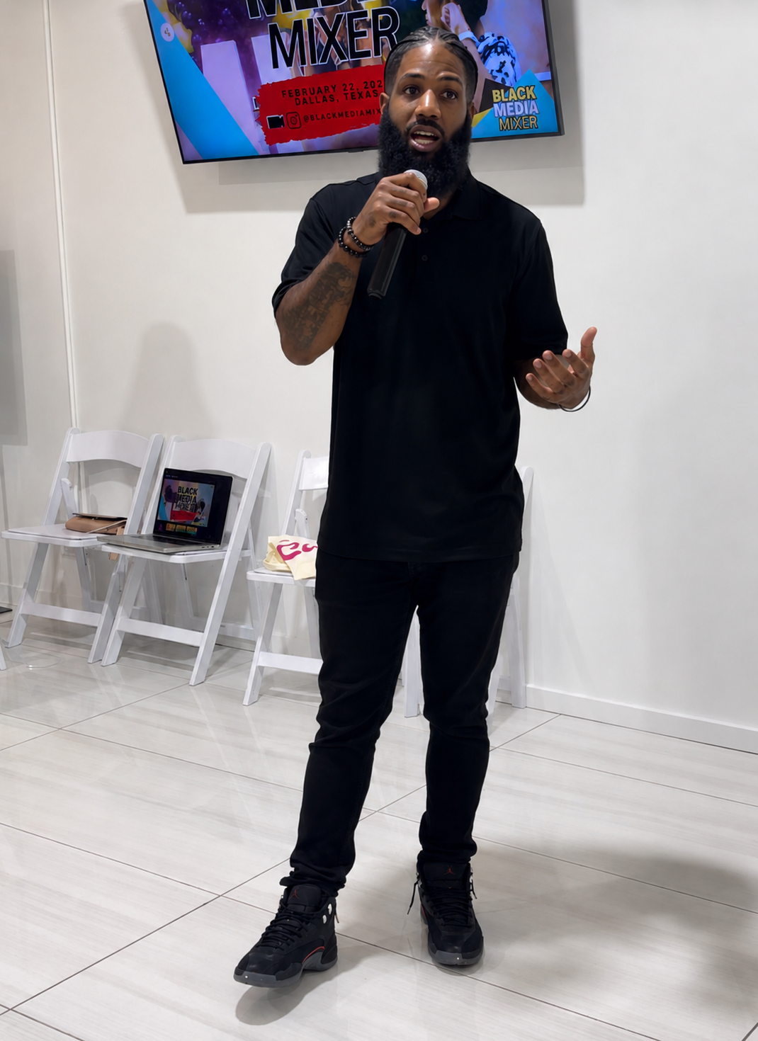 Coach Price speaking to an audience at a Dallas event