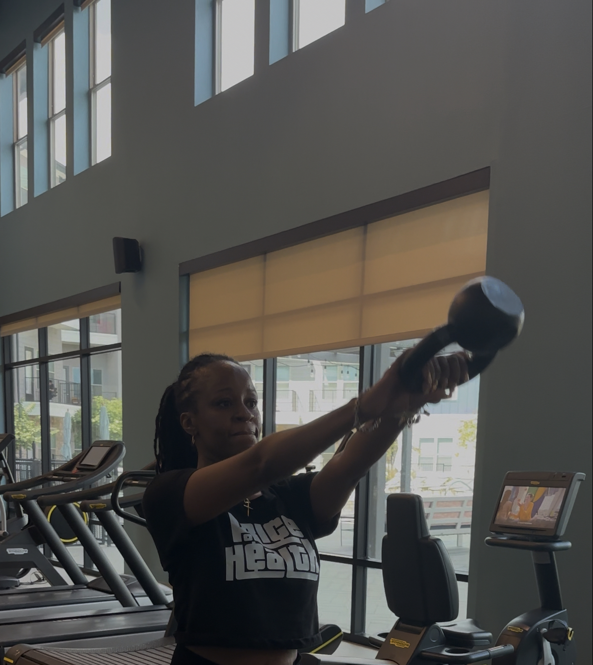 A client performing a kettlebell swing during a training session