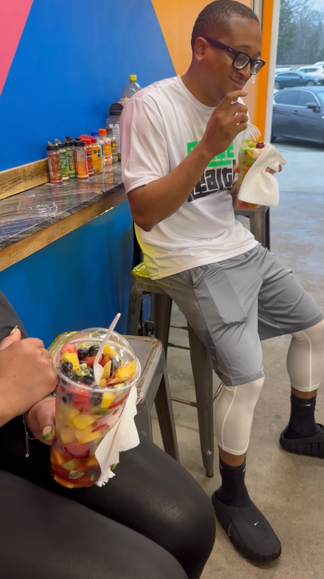 Community members enjoying fresh fruit cups after a group hike