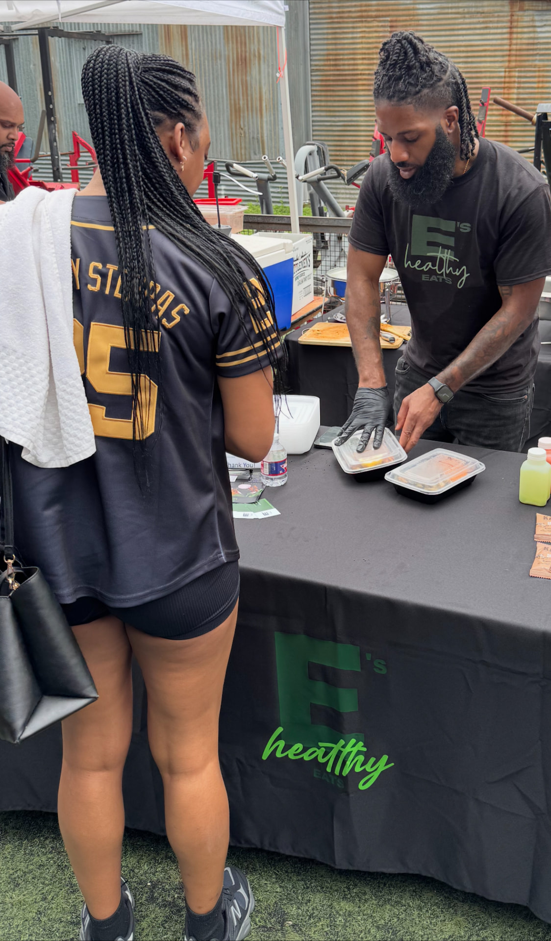 E's Healthy Eats team serving prepared meals at a community event