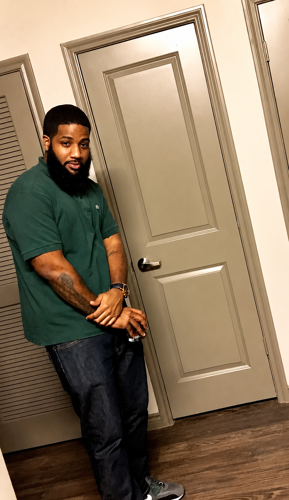 Earl before beginning his health journey, wearing a dark green shirt and dark jeans